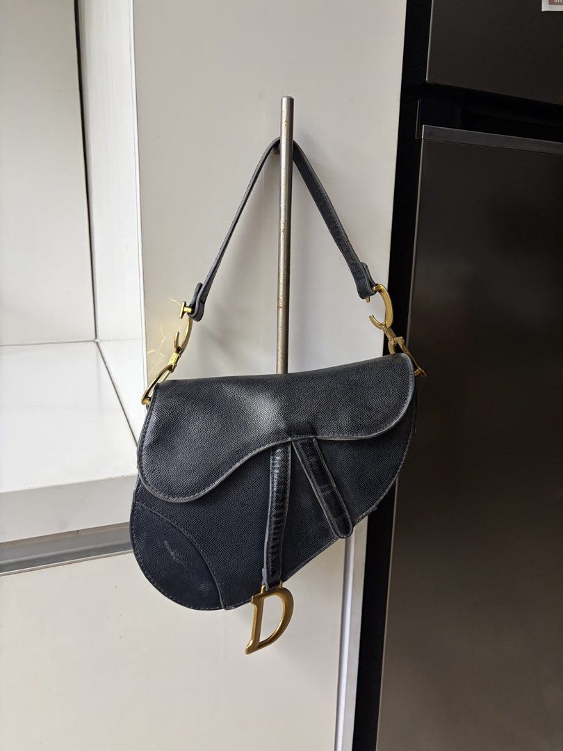 Dior Saddle Bag Black Leather Gold Hardware (Category: Luxury Bags & Wallets) located in Manila. Submitted by itaintgavin (Listing ID 1456127975, Image 3). Description: - Classic black leather Dior saddle bag - Features gold 'D' charm - Adjustable strap for versatile wear - A timeless and iconic piece - negotiable .