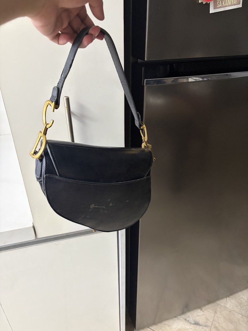 Dior Saddle Bag Black Leather Gold Hardware (Category: Luxury Bags & Wallets) located in Manila. Submitted by itaintgavin (Listing ID 1456127975, Image 2). Description: - Classic black leather Dior saddle bag - Features gold 'D' charm - Adjustable strap for versatile wear - A timeless and iconic piece - negotiable .