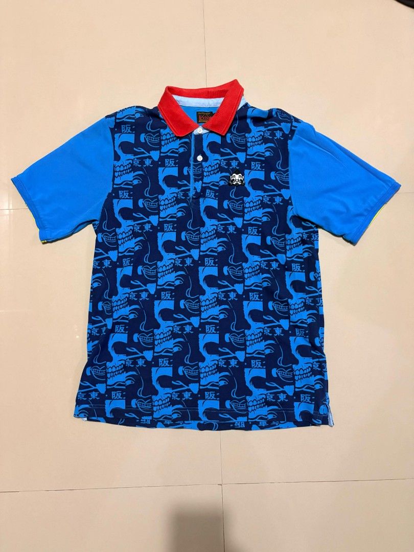 Evisu Custom Made Polo Shirt (Category: Tshirts & Polo Shirts ) located in Castillejos. Submitted by fnds_wr (Listing ID 1456192800, Image 1). Description: - Blue Evisu polo shirt - Unique all-over print featuring skulls and Japanese characters - Contrasting red collar detail - Short sleeves - Button-up front - Ideal for casual outfits.