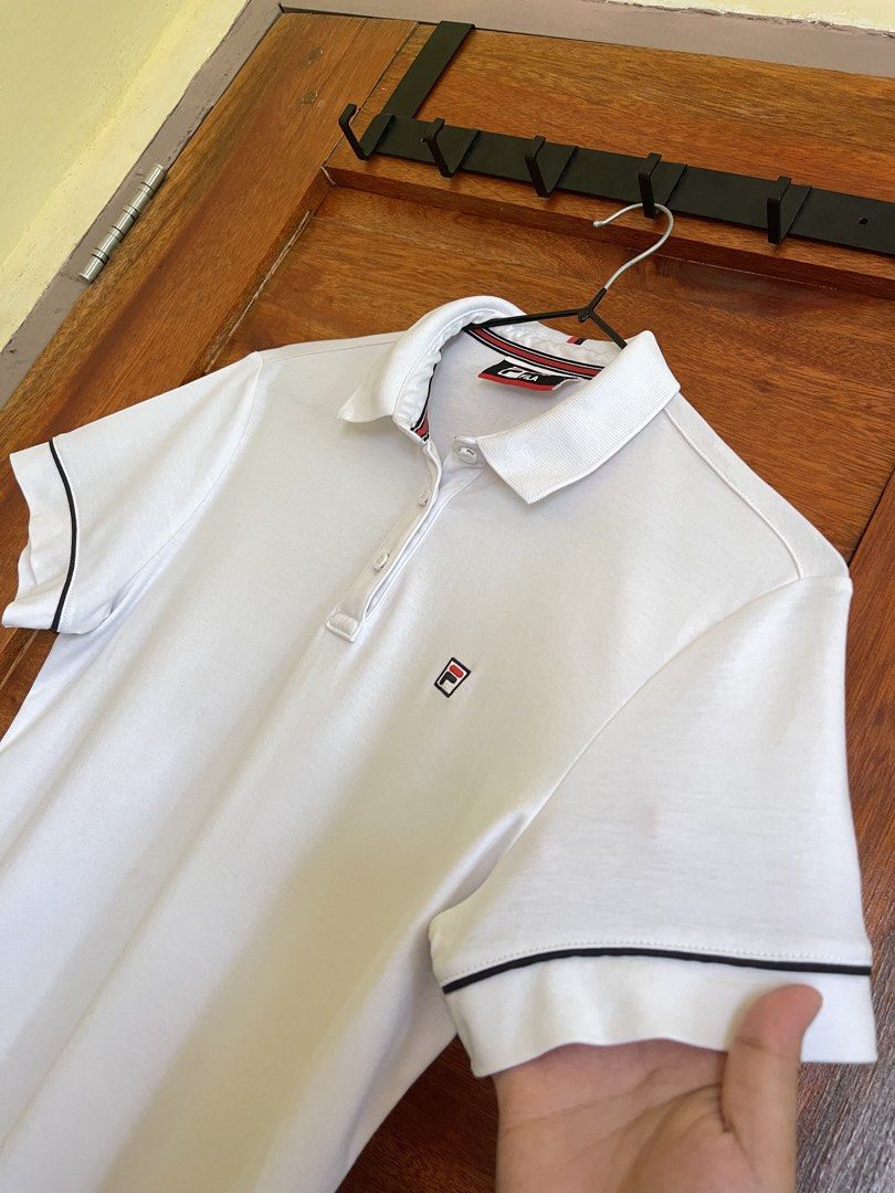 Fila Polo Shirt (Category: Shirts) located in Baler. Submitted by declutterwithrhys (Listing ID 1456185162, Image 2). Description: FOR SALE (PLEASE MAKE READING A HABIT) FILA WHITE POLO SHIRT EMBROIDERED LOGO COMPLETE TAGS AND WASH TAG WITH EXTRA BUTTON SIZE MEDIUM ON TAG WIDTH 17.5 TO 18.5 INCHES | LENGTH 24 INCHES BEST FIT SIZE EXTRA SMALL TO SEMI MEDIUM BODY FRAME COTTON FABRIC AUTHENTIC | ORIGINAL KINDLY CHECK THE PHOTOS FOR THE COMPLETE DETA