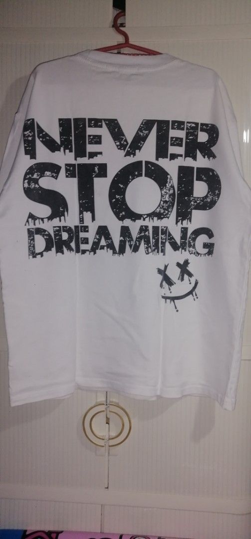 Givenchy Paris White Rhinestone Logo T-shirt (Category: Tshirts & Polo Shirts ) located in Quezon City. Submitted by rolenalma (Listing ID 1456123424, Image 2). Description: - Authentic Givenchy Paris T-shirt - Features a sparkling rhinestone logo on the front - Back design: 'Never Stop Dreaming' graphic with a smiley face - Ideal for casual and everyday wear - Please check all photos for detailed condition.