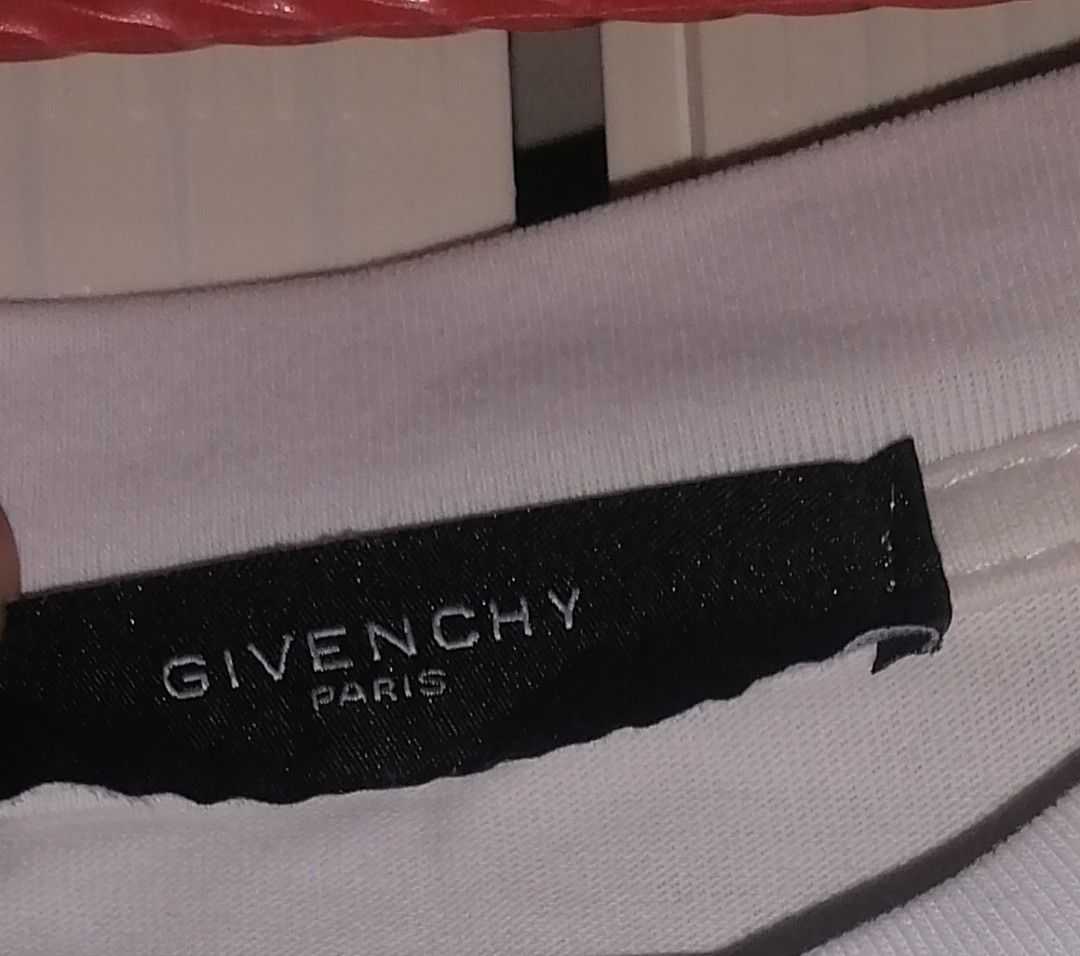 Givenchy Paris White Rhinestone Logo T-shirt (Category: Tshirts & Polo Shirts ) located in Quezon City. Submitted by rolenalma (Listing ID 1456123424, Image 3). Description: - Authentic Givenchy Paris T-shirt - Features a sparkling rhinestone logo on the front - Back design: 'Never Stop Dreaming' graphic with a smiley face - Ideal for casual and everyday wear - Please check all photos for detailed condition.