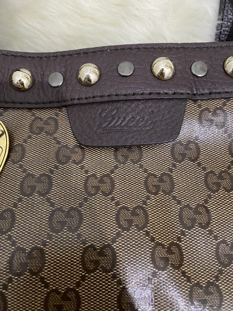 Gucci Bag (Category: Luxury Bags & Wallets) located in San Antonio. Submitted by clinicallycute_. (Listing ID 1456176769, Image 3). Description: - Gucci tote bag with code - Classic GG monogram canvas - Brown leather trim and handles - Decorative heart charm with Gucci logo - Studded details along the top edge - Interior zip pocket - Made in Italy.