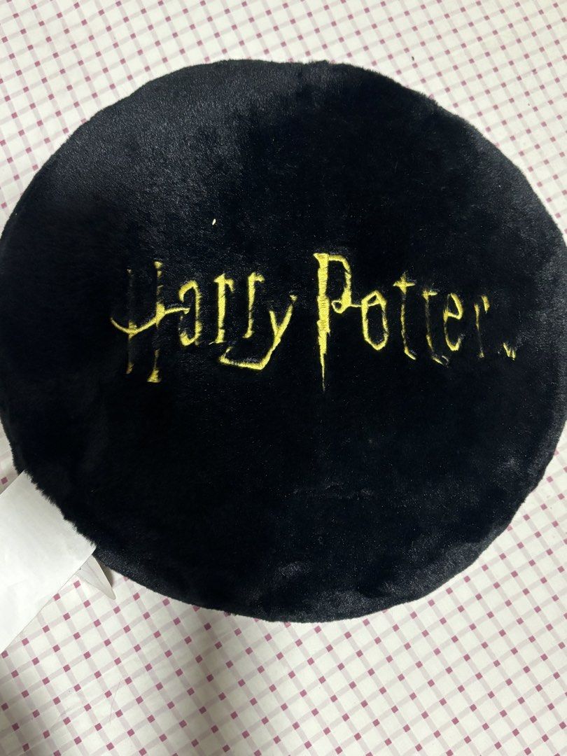 Harry Potter Hogwarts Crest Black Plush Round Pillow (Category: Bedding & Towels) located in Quezon City. Submitted by ricalazo (Listing ID 1456200686, Image 2). Description: - Black plush round pillow - Features embroidered Hogwarts crest in gold - 'Harry Potter' embroidered in gold on the back - Made of soft and fuzzy material - Ideal for Harry Potter fans' rooms or as a comfy cushion Never displayed. Triggers my allergies. .