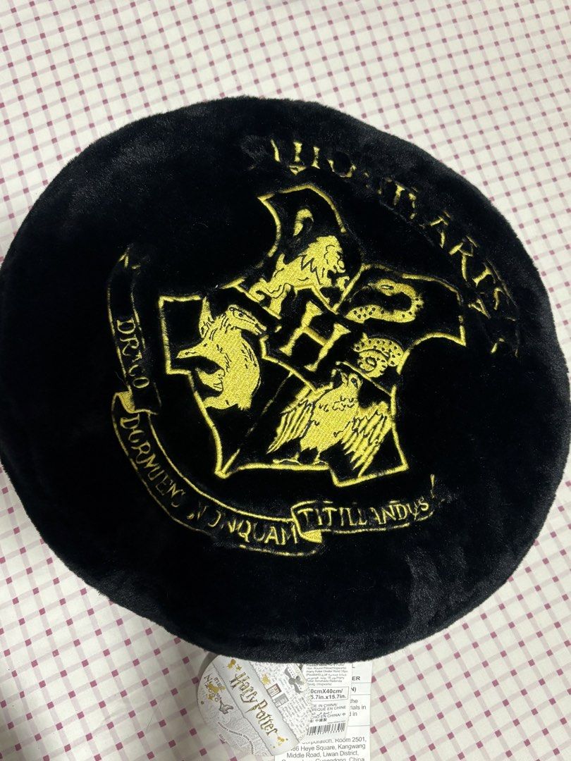 Harry Potter Hogwarts Crest Black Plush Round Pillow (Category: Bedding & Towels) located in Quezon City. Submitted by ricalazo (Listing ID 1456200686, Image 1). Description: - Black plush round pillow - Features embroidered Hogwarts crest in gold - 'Harry Potter' embroidered in gold on the back - Made of soft and fuzzy material - Ideal for Harry Potter fans' rooms or as a comfy cushion Never displayed. Triggers my allergies. .
