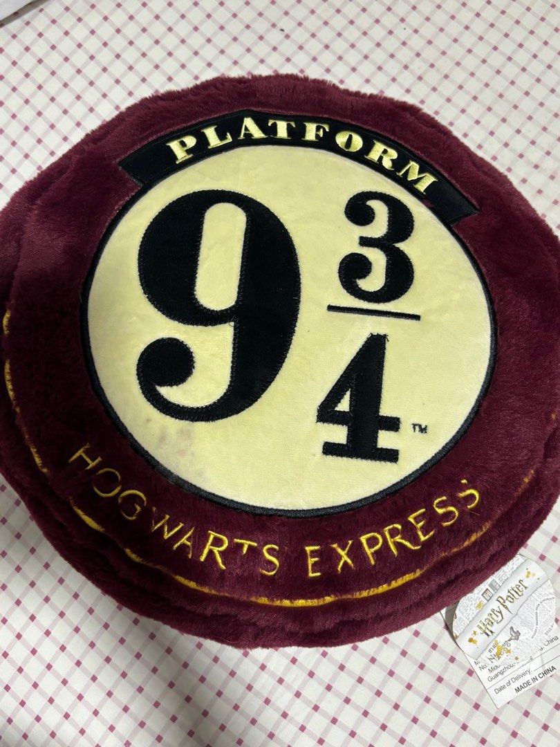 Harry Potter Hogwarts Express Platform 9 3/4 Plush Cushion (Category: Western Merchandise) located in Quezon City. Submitted by ricalazo (Listing ID 1456200889, Image 1). Description: - Super soft plush cushion - Features iconic Harry Potter Platform 9 3/4 design - 'Harry Potter' embroidered in gold on the back - Measures approximately 15 inches in diameter - Ideal for any Harry Potter fan's room or as a comfy throw pillow Never displayed. Trigge