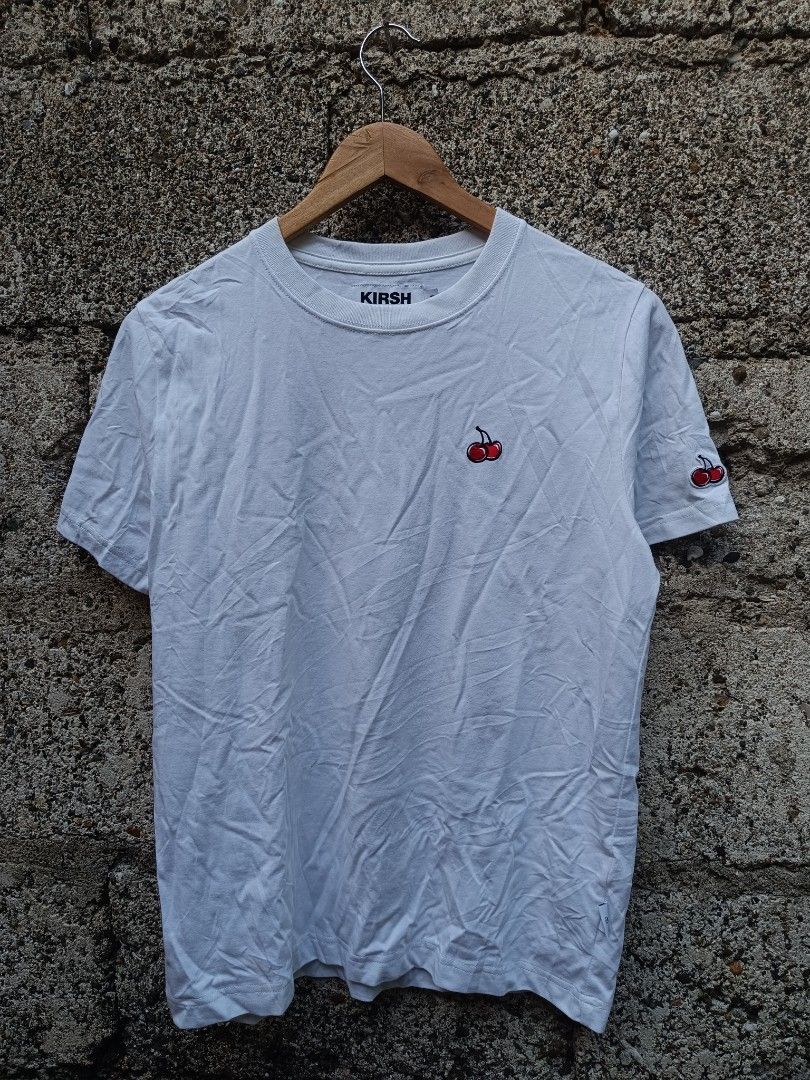 Kirsh White T-shirt with Cherry Logo (Category: Tshirts & Polo Shirts ) located in Tubigon. Submitted by thrift_mac (Listing ID 1456067484, Image 1). Description: - Classic white Kirsh t-shirt - Features signature cherry logo embroidered on chest and sleeve - Made from comfortable material - Ideal for everyday casual wear - Versatile and easy to pair with any outfit - issue black stain.