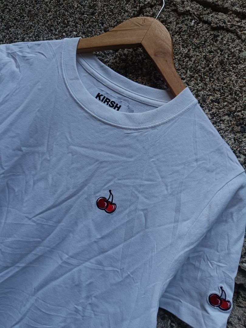 Kirsh White T-shirt with Cherry Logo (Category: Tshirts & Polo Shirts ) located in Tubigon. Submitted by thrift_mac (Listing ID 1456067484, Image 2). Description: - Classic white Kirsh t-shirt - Features signature cherry logo embroidered on chest and sleeve - Made from comfortable material - Ideal for everyday casual wear - Versatile and easy to pair with any outfit - issue black stain.