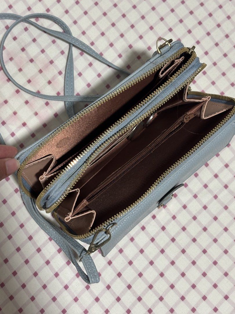 Light Blue Textured Wallet Bag with Strap (Category: Luxury Bags & Wallets) located in Quezon City. Submitted by ricalazo (Listing ID 1456201596, Image 2). Description: - Light blue textured wallet bag - Main zip compartment - Front flap pocket with magnetic closure - Long, adjustable strap included - Multiple card slots and compartments inside - Perfect for organizing your essentials Used only couple of times .