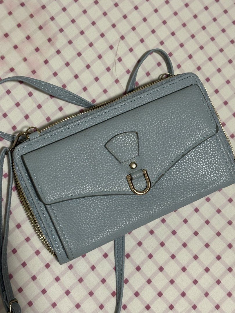 Light Blue Textured Wallet Bag with Strap (Category: Luxury Bags & Wallets) located in Quezon City. Submitted by ricalazo (Listing ID 1456201596, Image 3). Description: - Light blue textured wallet bag - Main zip compartment - Front flap pocket with magnetic closure - Long, adjustable strap included - Multiple card slots and compartments inside - Perfect for organizing your essentials Used only couple of times .