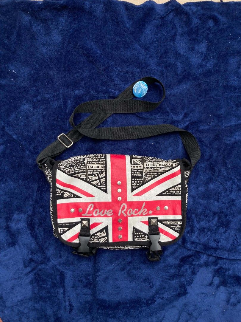 Love Rock Messenger Bag (Category: Sling Bags) located in Naga. Submitted by grunchieeeerr (Listing ID 1456108966, Image 1). Description: Cool Union Jack messenger bag with 'Love Rock' design. Features buckle and zip closures, adjustable strap. Perfect for daily use or concerts. 10x15.