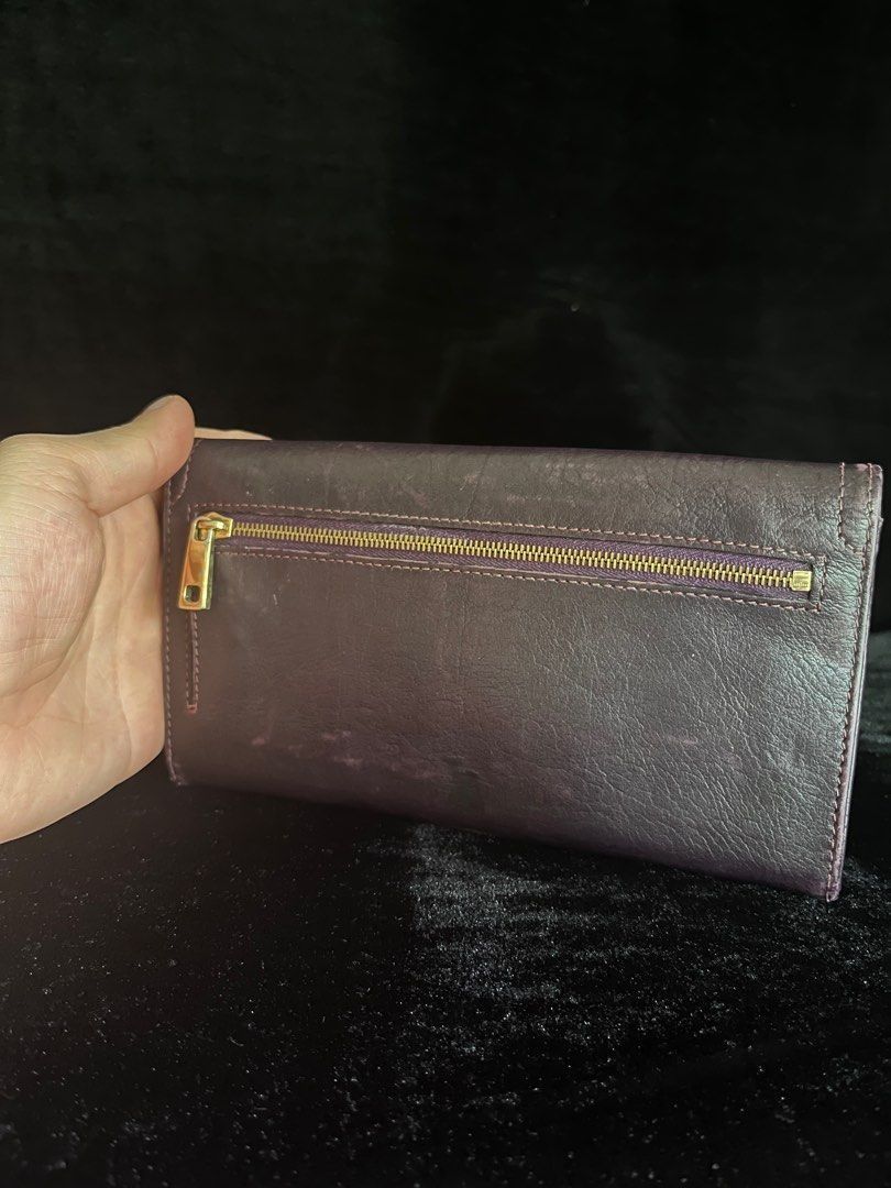 Marc Jacobs Leather Wallet Made in Italy (Category: Wallets & Card holders) located in Talisay. Submitted by jingcas (Listing ID 1456124808, Image 2). Description: - Authentic Marc Jacobs wallet - Deep purple/burgundy genuine leather exterior - Interior features multiple card slots - Includes a zippered compartment for coins or other essentials - "Made in Italy" craftsmanship - Perfect for organizing your daily necessities.