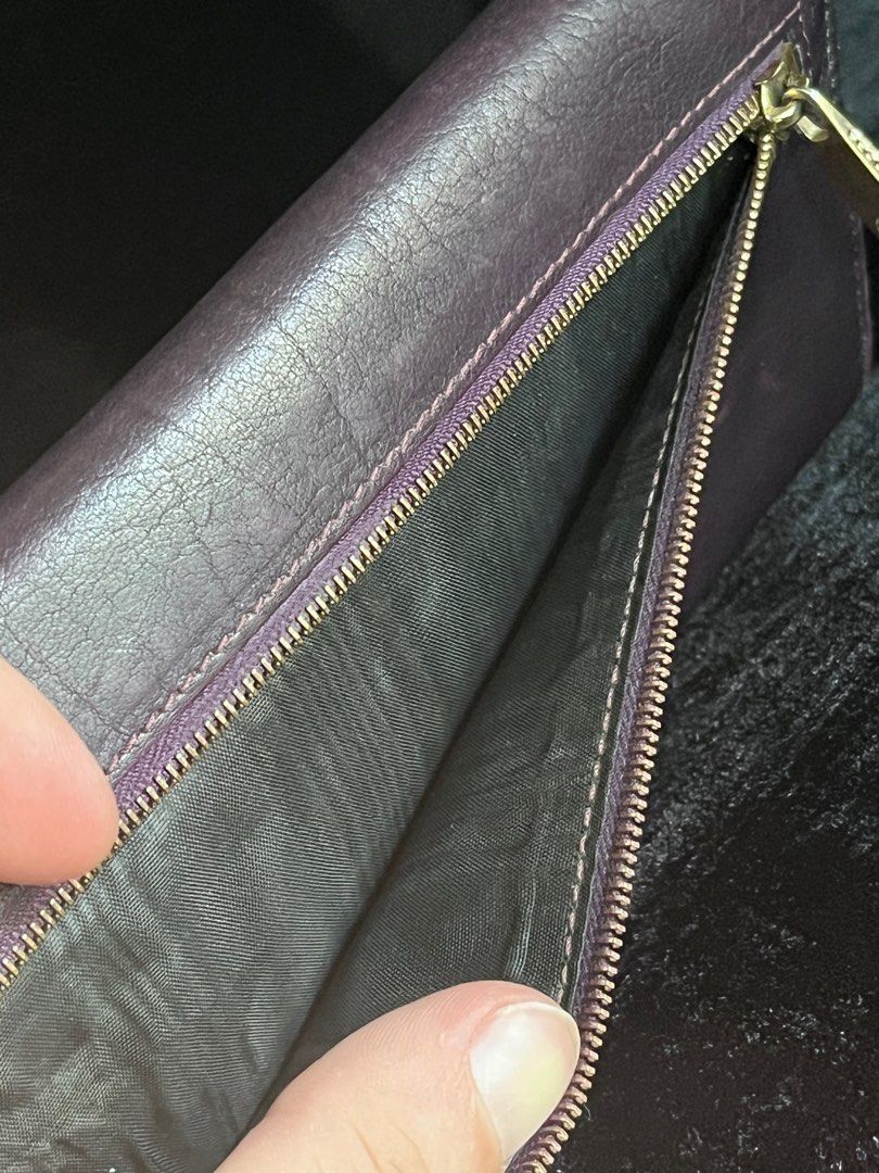 Marc Jacobs Leather Wallet Made in Italy (Category: Wallets & Card holders) located in Talisay. Submitted by jingcas (Listing ID 1456124808, Image 3). Description: - Authentic Marc Jacobs wallet - Deep purple/burgundy genuine leather exterior - Interior features multiple card slots - Includes a zippered compartment for coins or other essentials - "Made in Italy" craftsmanship - Perfect for organizing your daily necessities.