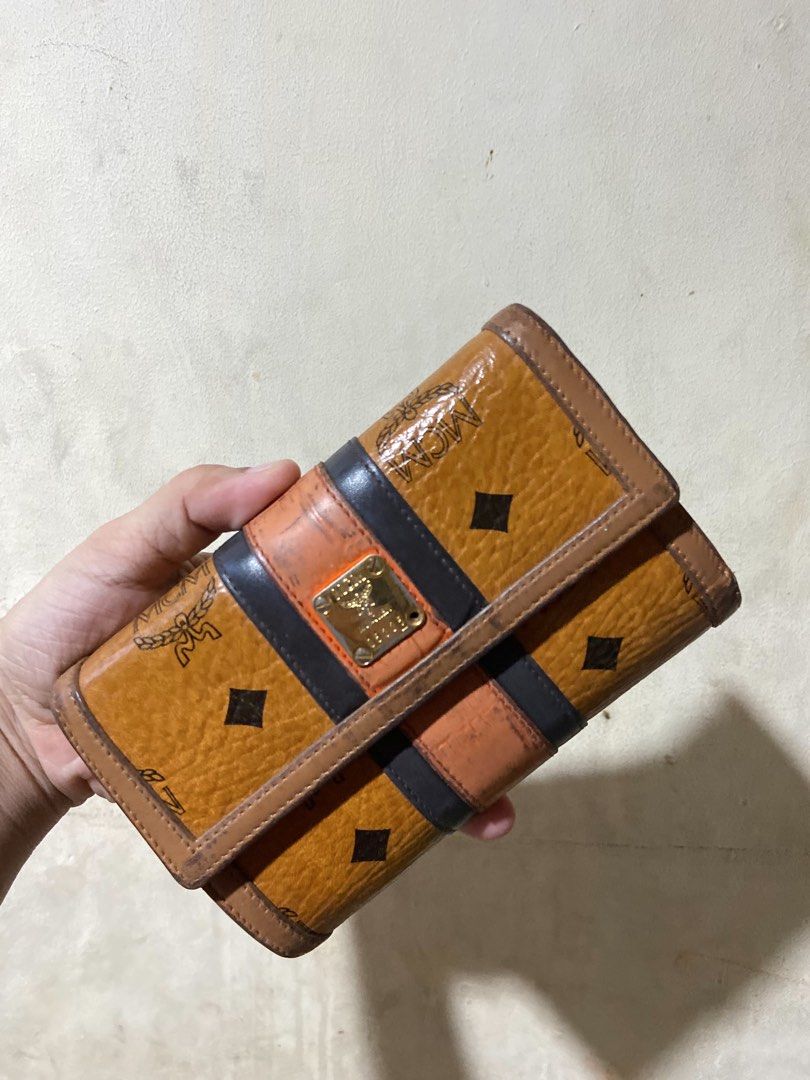 MCM Visetos Trifold Wallet Cognac (Category: Luxury Bags & Wallets) located in Manila. Submitted by starbalesukandjapansurplus (Listing ID 1456084461, Image 1). Description: - Authentic MCM wallet - Classic Visetos print - Trifold design - Multiple card slots - Clear ID window - Interior is clean - Stylish and practical for everyday use.