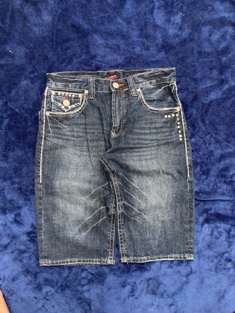 Men's Embellished Denim Shorts (Category: Shorts) located in Naga. Submitted by grunchieeeerr (Listing ID 1456106706, Image 3). Description: Dark wash denim shorts with silver stud and cross embroidery on back pockets. Orange contrast stitching. Button/zip closure. Minor storage creases. Perfect for casual outfits. 32x24.