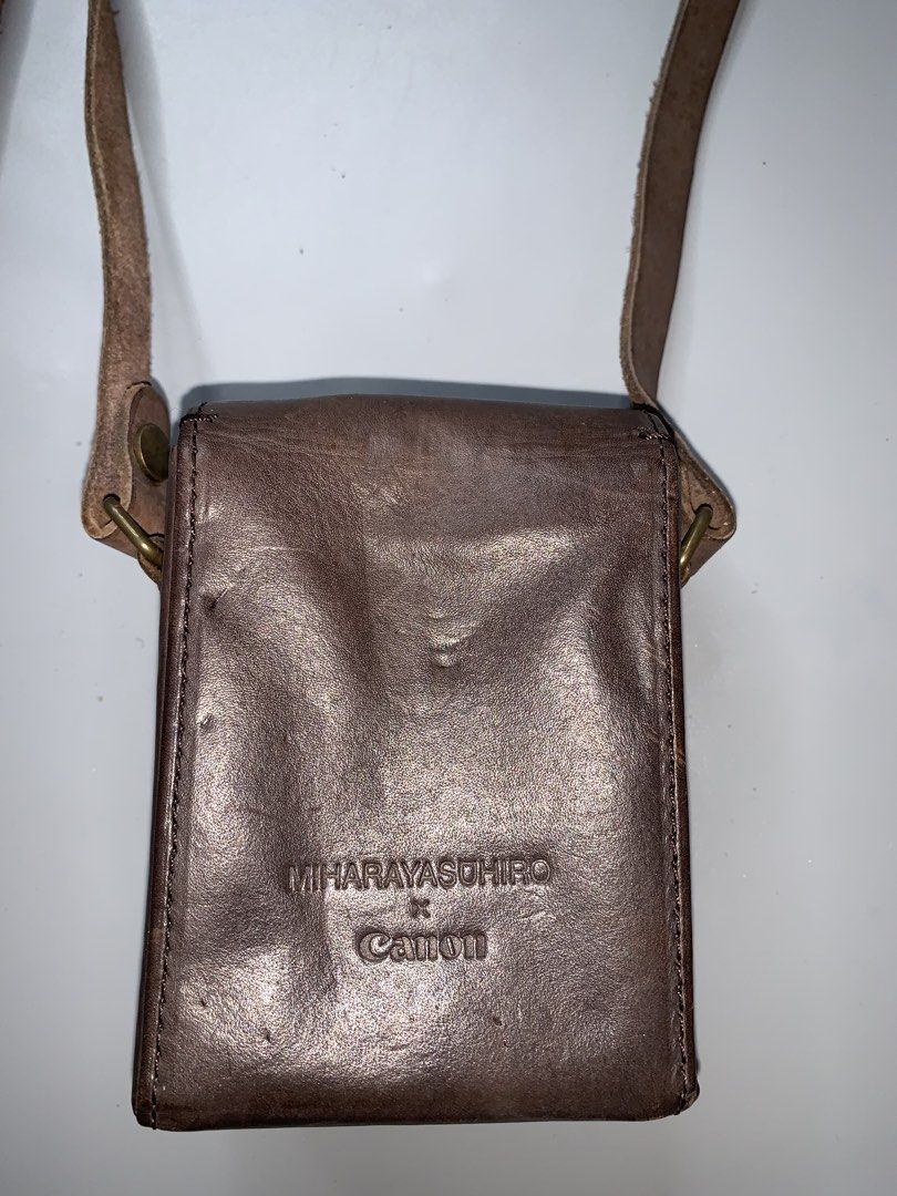 Mihara Yasuhiro x Canon Sling Bag (Category: Sling Bags) located in Binan City. Submitted by hybrid_archival_theory (Listing ID 1456186418, Image 3). Description: Mihara Yasuhiro Leather Camera Bag Collaboration With Canon Rare Piece Limited edition USED Measurements- Height- 9 cm Width- 8 cm No Inclusions Bag only Please Check Detailed Photos Posted For Your Reference Thankyou! •is a Miharayasuhiro Leather Camera Bag, specifically created as a r