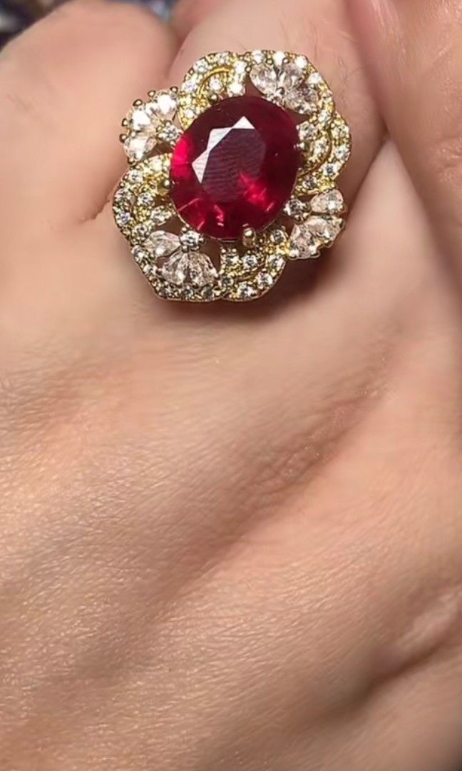Mozambique Ruby Ring (Category: Rings) located in Kota Kinabalu. Submitted by cahayabulan123 (Listing ID 1456185996, Image 1). Description: Stunning Design: Features a vibrant red lab-created ruby center stone with an elegant halo setting. ​Specifications: Total weight of 6.70g with certified laboratory authenticity. ​Great Value: A bold, statement-making piece offering a luxurious look at an affordable price. ​Quality Materials: Set on a durable