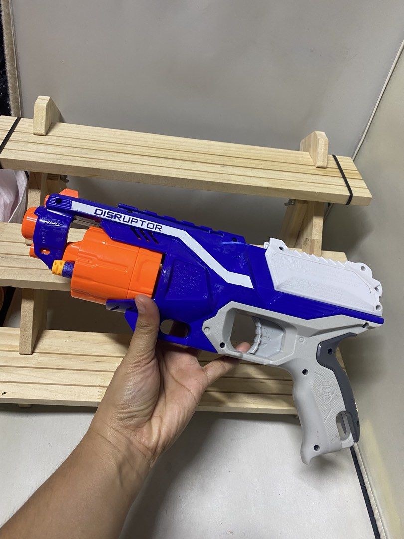 Nerf Elite Disruptor Blaster Toy Gun (Category: Action & Battle Toys) located in Pasacao. Submitted by wengpullar37205 (Listing ID 1456216160, Image 2). Description: - Blue and white Nerf Elite Disruptor blaster - Features an orange rotating barrel - Fires darts for exciting play - Perfect for kids and adults - Ready for action!.