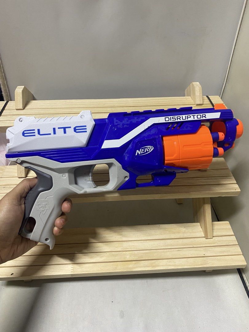 Nerf Elite Disruptor Blaster Toy Gun (Category: Action & Battle Toys) located in Pasacao. Submitted by wengpullar37205 (Listing ID 1456216160, Image 1). Description: - Blue and white Nerf Elite Disruptor blaster - Features an orange rotating barrel - Fires darts for exciting play - Perfect for kids and adults - Ready for action!.