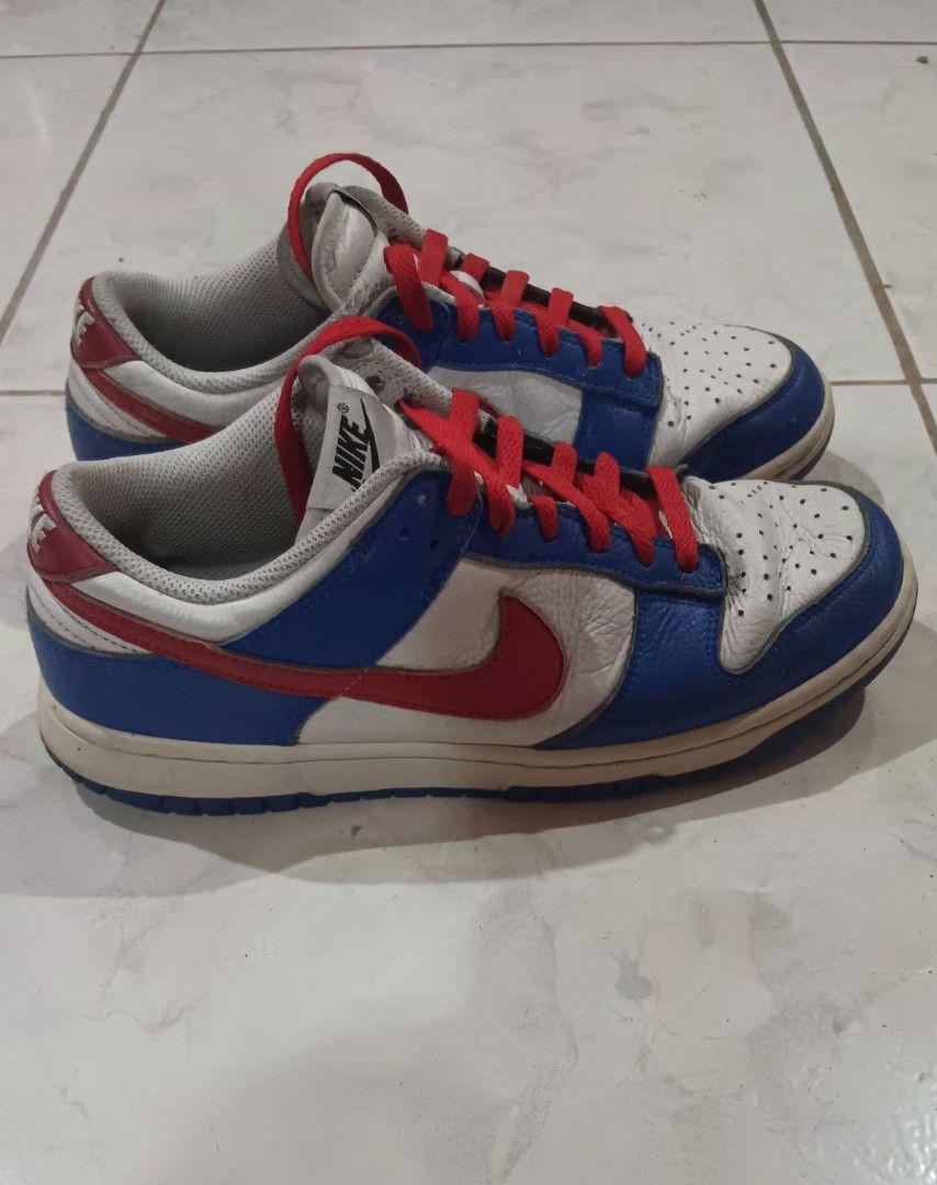 Nike Dunk Low White Blue Red (Category: Sneakers) located in Manila. Submitted by nicko1107 (Listing ID 1456127281, Image 3). Description: - Authentic Nike Dunk Lows - Size 8.5M 26.5cm - Classic white, blue, and red colorway - Features striking red laces - Shows minor creasing on the toe box from normal wear - Soles are in decent condition - Plenty of life remaining for continued use.
