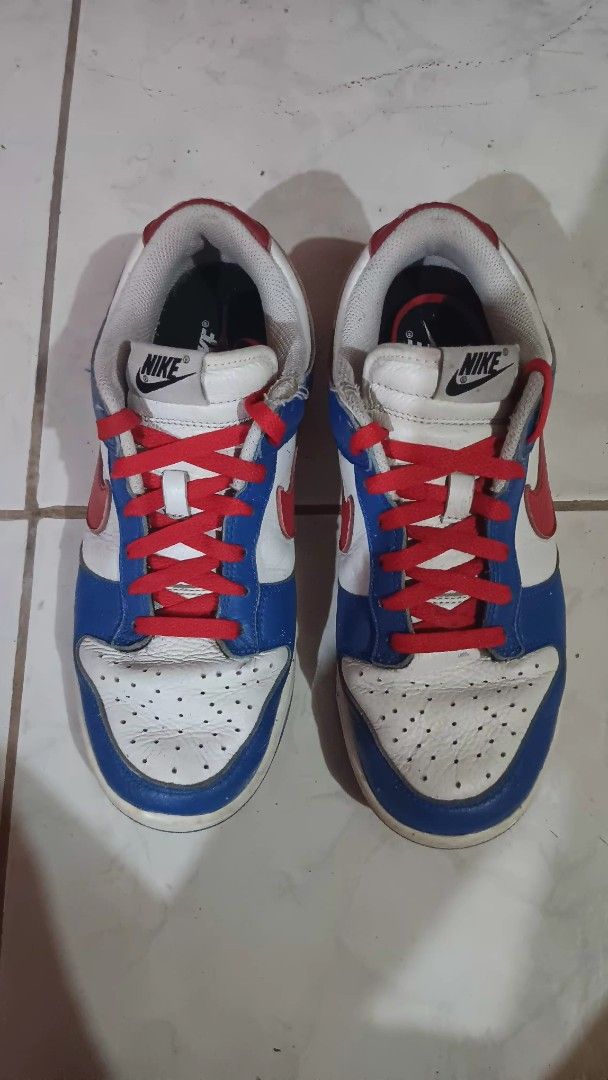 Nike Dunk Low White Blue Red (Category: Sneakers) located in Manila. Submitted by nicko1107 (Listing ID 1456127281, Image 1). Description: - Authentic Nike Dunk Lows - Size 8.5M 26.5cm - Classic white, blue, and red colorway - Features striking red laces - Shows minor creasing on the toe box from normal wear - Soles are in decent condition - Plenty of life remaining for continued use.
