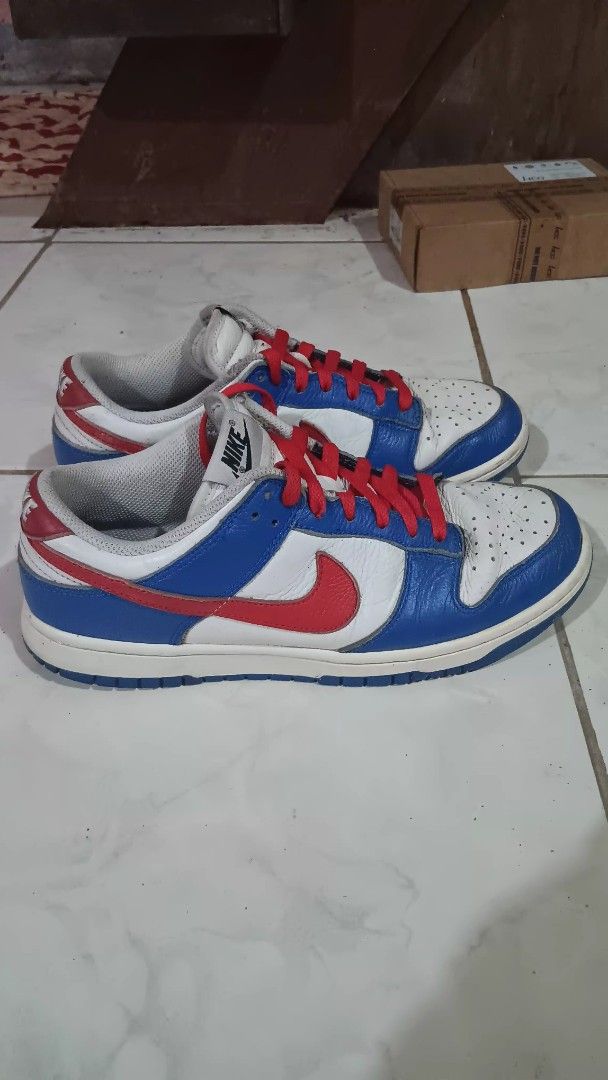 Nike Dunk Low White Blue Red (Category: Sneakers) located in Manila. Submitted by nicko1107 (Listing ID 1456127281, Image 2). Description: - Authentic Nike Dunk Lows - Size 8.5M 26.5cm - Classic white, blue, and red colorway - Features striking red laces - Shows minor creasing on the toe box from normal wear - Soles are in decent condition - Plenty of life remaining for continued use.