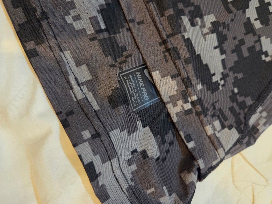 Nike Pro Hypercool Compression Digital Camo T-shirt (Category: Activewear) located in Taguig. Submitted by mightydept (Listing ID 1456135999, Image 3). Description: - Nike Pro Hypercool Compression T-Shirt - Digital camouflage pattern (grey & black) - Short sleeves - Ideal for workouts and athletic activities - Breathable fabric for enhanced comfort - Size: Medium (M).