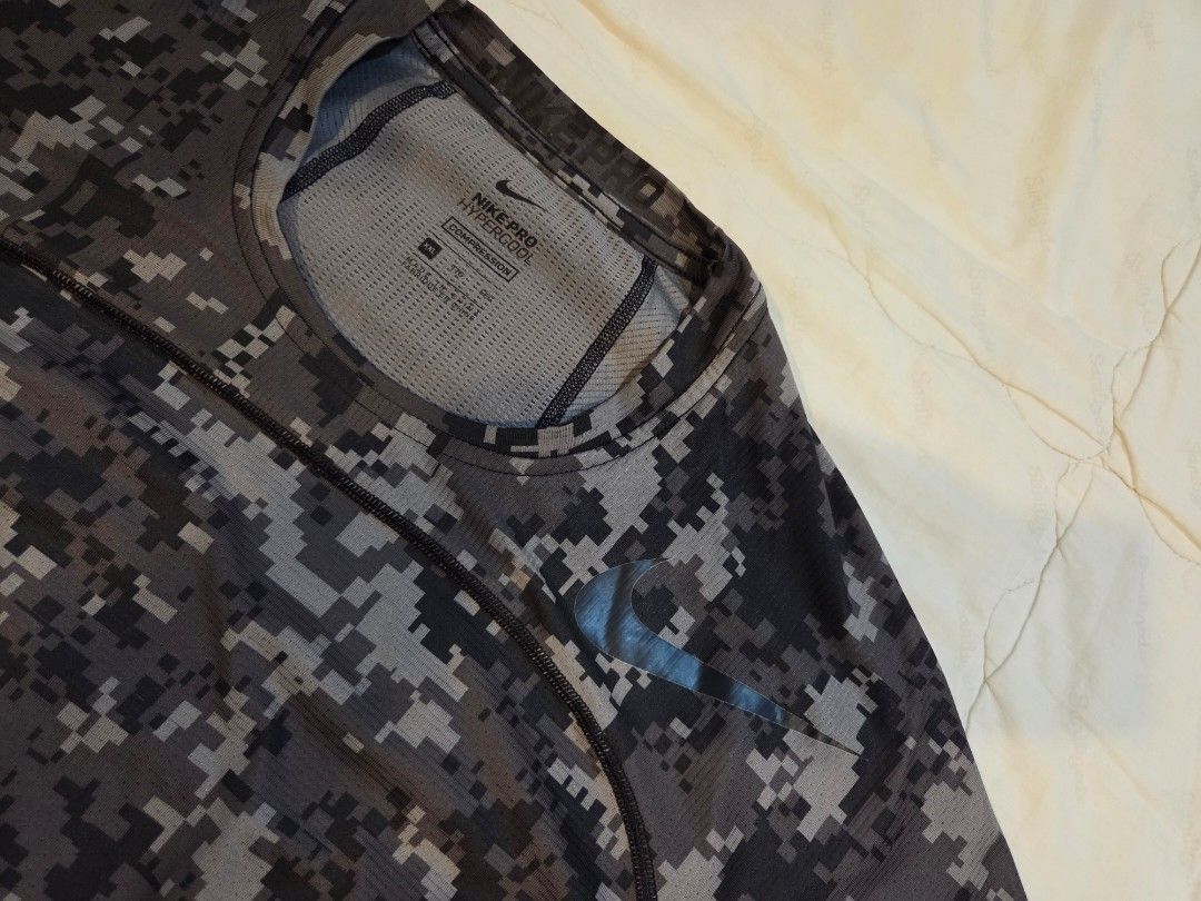 Nike Pro Hypercool Compression Digital Camo T-shirt (Category: Activewear) located in Taguig. Submitted by mightydept (Listing ID 1456135999, Image 2). Description: - Nike Pro Hypercool Compression T-Shirt - Digital camouflage pattern (grey & black) - Short sleeves - Ideal for workouts and athletic activities - Breathable fabric for enhanced comfort - Size: Medium (M).