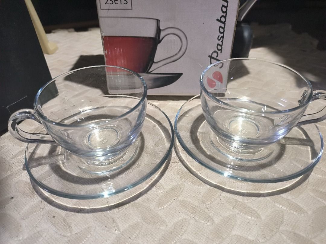 Pasabahce Basic 2 Sets Glass Tea Cups and Saucers (Category: Coffee & Tea Tableware) located in Manila. Submitted by silent_vonachiles (Listing ID 1456141579, Image 2). Description: - Set of 2 clear glass tea cups and saucers - Brand: Pasabahce, Basic Collection - Ideal for morning tea or coffee - Original box included, shows some wear.