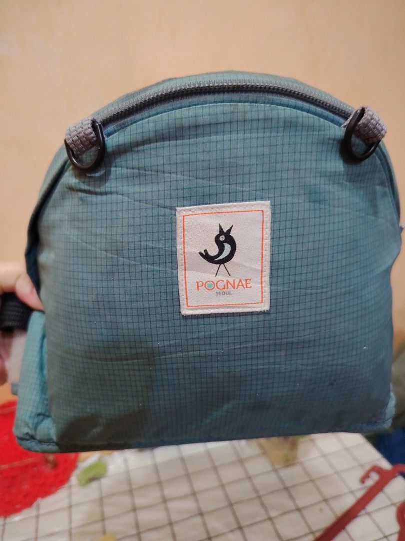 Pognae hip seat (Category: Carriers & Slings) located in Taguig. Submitted by mackz13triftshop (Listing ID 1456227167, Image 2). Description: POGNAE HIP SEAT ➡️teal/blue ➡️grid pattern fabric ➡️durable zipper and adjustable strap ➡️light weight padded fabric ➡️ISSUE->the instructional level is frayed with loose threads--edges unraveling,stitching coming undone(see the last pic) but the carrier itself is intact ➡️ideal for daily errands ➡️payment 