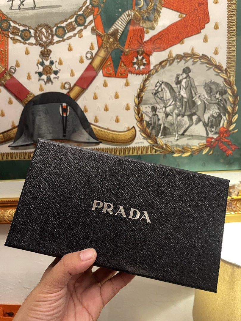 Prada Black Textured Box (Category: Luxury Bags & Wallets) located in Marilao. Submitted by wardrovearchives (Listing ID 1456215659, Image 1). Description: - Genuine Prada box - Textured Saffiano leather finish - Iconic silver Prada logo on top - Ideal for storing small valuables or as a luxurious gift box .