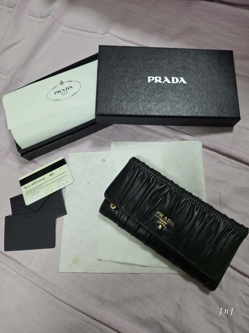 Prada Nappa Gaufre Wallet Black (Category: Luxury Bags & Wallets) located in Pasig City. Submitted by cecilececile4361 (Listing ID 1456154234, Image 1). Description: - Authentic Prada Wallet - Material: Black Nappa Gaufre - Includes Original Box - Includes Authenticity Card - Purchase Year: 2011 - Multiple Card Slots - Numerous Compartments - Perfect for organizing essentials.