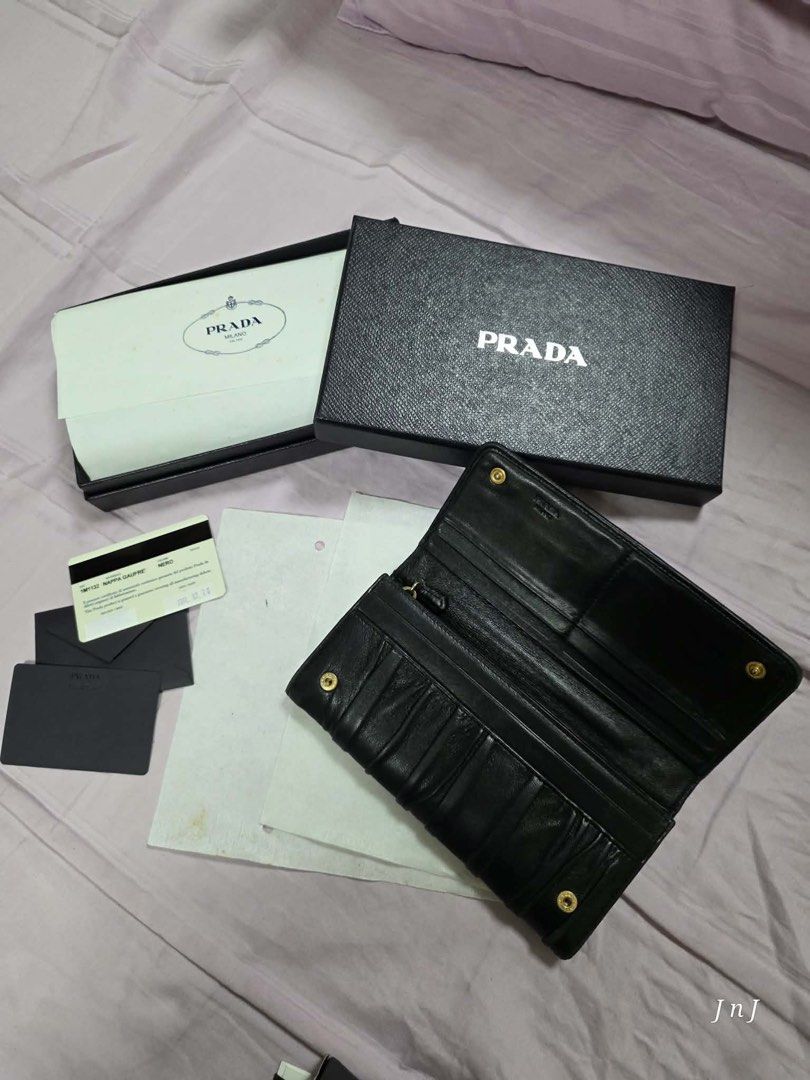 Prada Nappa Gaufre Wallet Black (Category: Luxury Bags & Wallets) located in Pasig City. Submitted by cecilececile4361 (Listing ID 1456154234, Image 3). Description: - Authentic Prada Wallet - Material: Black Nappa Gaufre - Includes Original Box - Includes Authenticity Card - Purchase Year: 2011 - Multiple Card Slots - Numerous Compartments - Perfect for organizing essentials.