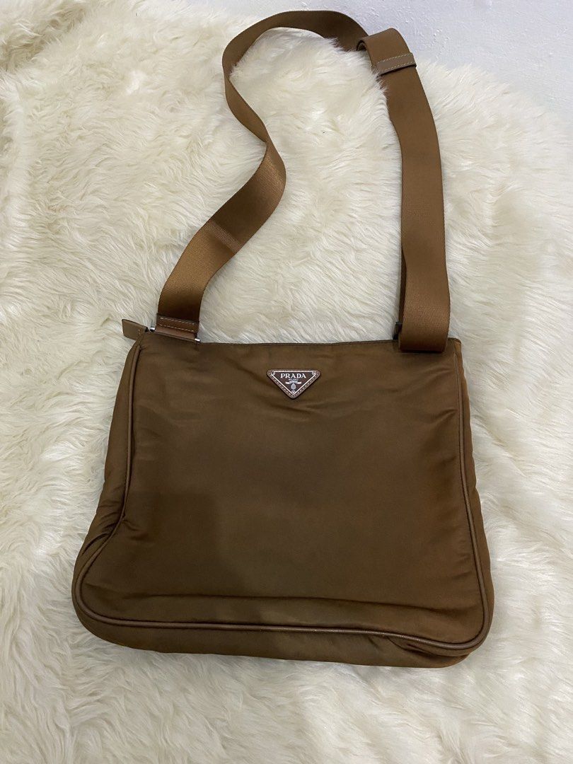 Prada Nylon Crossbody Bag (Category: Luxury Bags & Wallets) located in San Antonio. Submitted by clinicallycute_. (Listing ID 1456176587, Image 1). Description: - Prada crossbody bag - Material: Nylon with leather trim - Features: Front zip pocket, interior zip pocket - Strap: Adjustable with Prada branding negotiable.