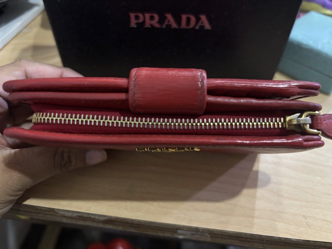 Prada Red Leather Zip Around Wallet with Box (Category: Luxury Bags & Wallets) located in Malabon City. Submitted by everythingpreloveddd (Listing ID 1456153581, Image 3). Description: - Authentic Prada wallet in vibrant red leather. - Secure zip-around closure. - Ample card slots and compartments for organization. - Comes with the original Prada box. - Ideal for keeping your essentials neatly stored..