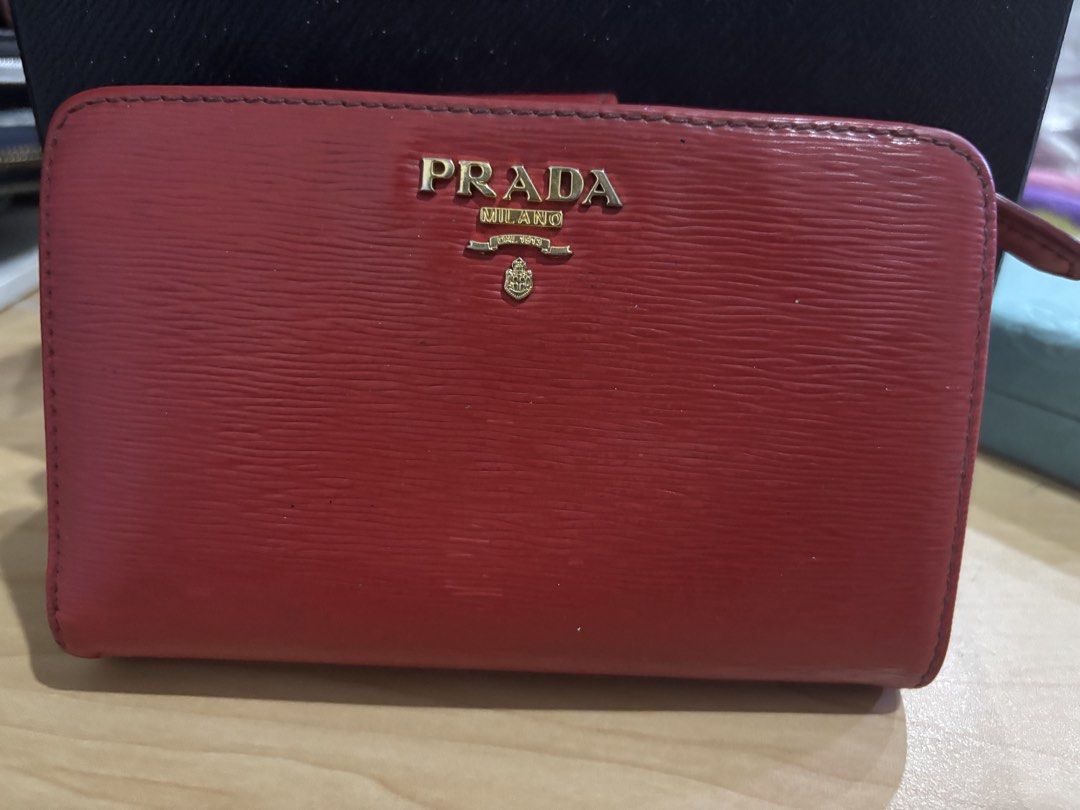 Prada Red Leather Zip Around Wallet with Box (Category: Luxury Bags & Wallets) located in Malabon City. Submitted by everythingpreloveddd (Listing ID 1456153581, Image 2). Description: - Authentic Prada wallet in vibrant red leather. - Secure zip-around closure. - Ample card slots and compartments for organization. - Comes with the original Prada box. - Ideal for keeping your essentials neatly stored..