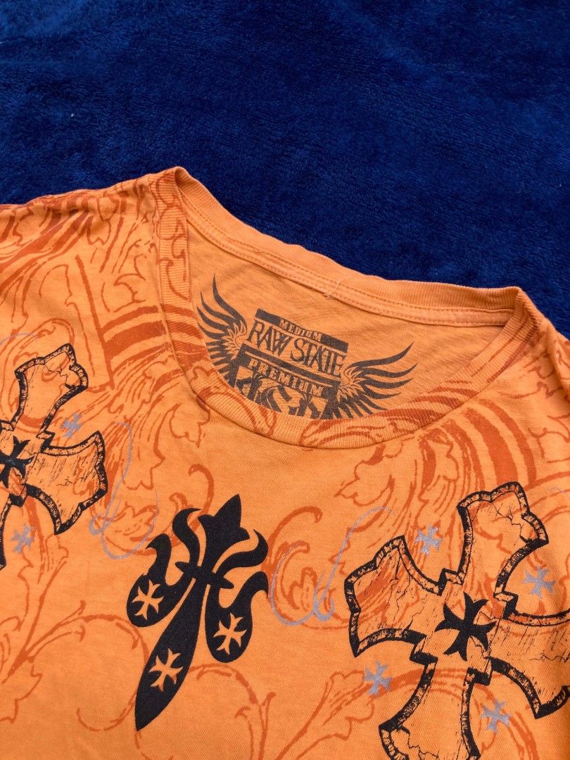 Raw State Premium (Category: Tshirts & Polo Shirts ) located in Naga. Submitted by grunchieeeerr (Listing ID 1456104627, Image 2). Description: Raw State Premium orange graphic tee, size Medium. Features cool cross and text designs on front and back. 19x27.