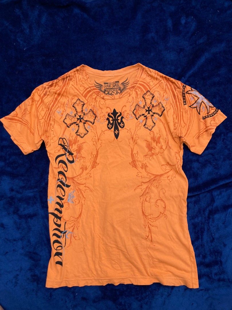 Raw State Premium (Category: Tshirts & Polo Shirts ) located in Naga. Submitted by grunchieeeerr (Listing ID 1456104627, Image 1). Description: Raw State Premium orange graphic tee, size Medium. Features cool cross and text designs on front and back. 19x27.