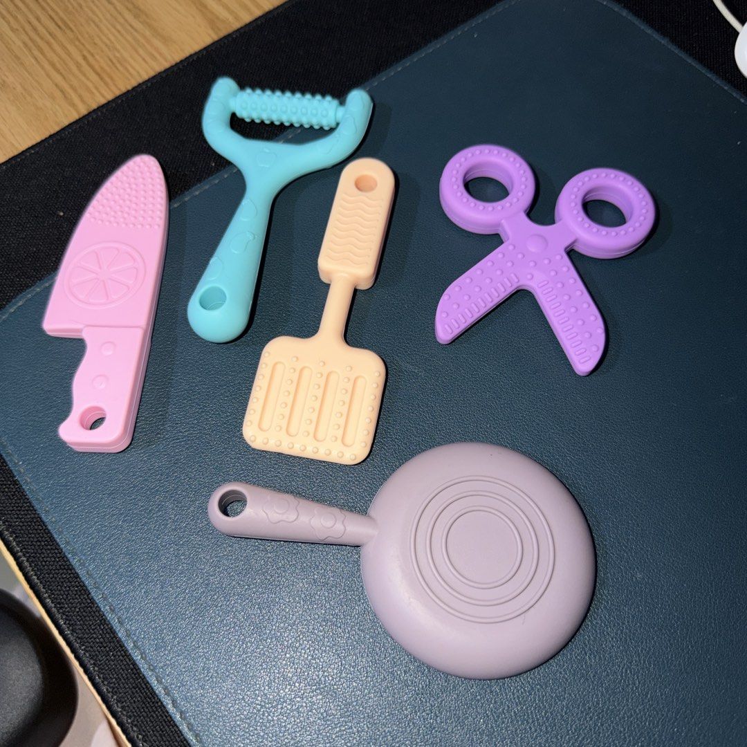 (Set of 5) Hoshi Baby Silicone Kitchen Tools Teethers (Category: Infant Playtime) located in Navotas City. Submitted by rahrahsevlau (Listing ID 1456158587, Image 3). Description: - Set of 5 fun silicone kitchen tool shaped teethers - Includes: frying pan, knife, peeler, spatula, and scissors - BPA-free and safe for babies - Suitable for babies 6 months and up - Provides relief for teething gums - Encourages sensory play and exploration Note: Cas