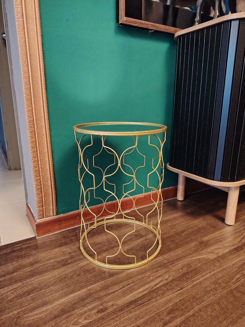 SIDE TABLE (Category: Tables & Sets) located in Kuala Lumpur. Submitted by khai.taufan (Listing ID 1456069377, Image 1). Description: - Elegant round side table - Features a striking gold metal geometric base - Mirror glass top - Ideal accent piece for living rooms, bedrooms, or entryways - Perfect for holding plants, drinks, or decorative items - Lightweight and easy to reposition - Dimensions: Approximately 18 inches tall and 12 inches diameter