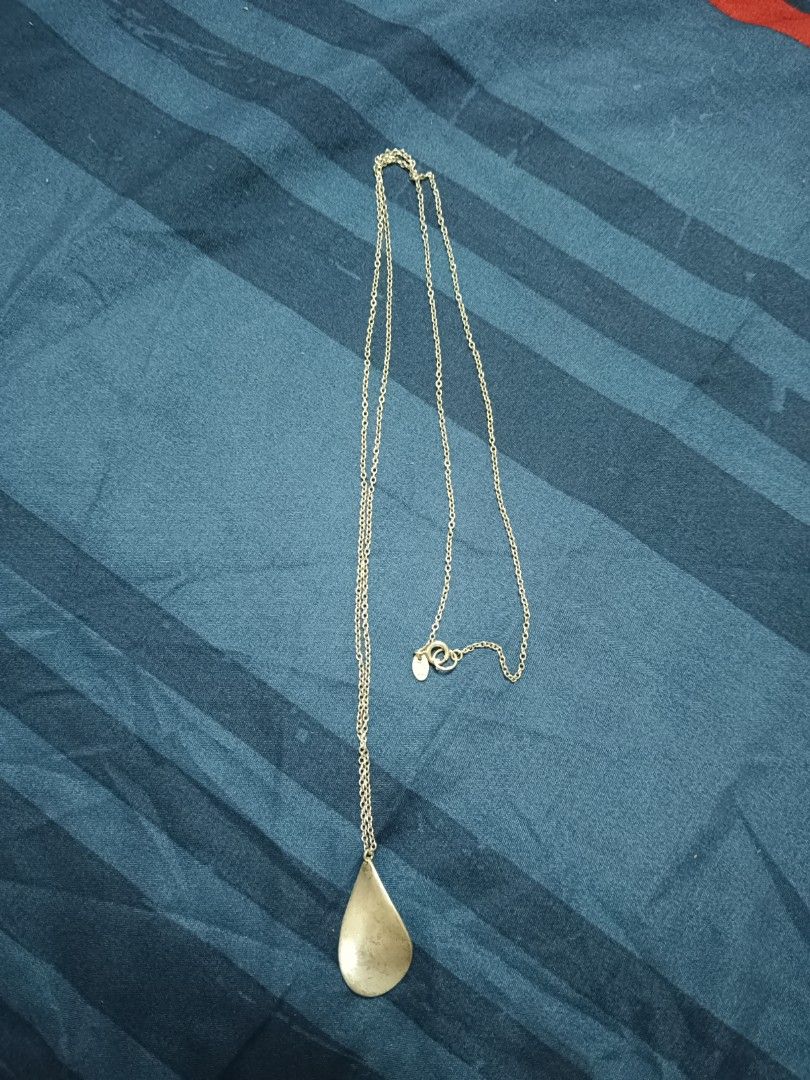 Silver Chain Necklace with Teardrop Pendant (Category: Necklaces) located in Manila. Submitted by clover_co. (Listing ID 1456208154, Image 2). Description: - Simple silver chain necklace - Features a long, thin chain - Adorned with a teardrop-shaped pendant - Clasp includes a small logo tag - Ideal for everyday wear or layering - Adjustable length for a perfect fit.