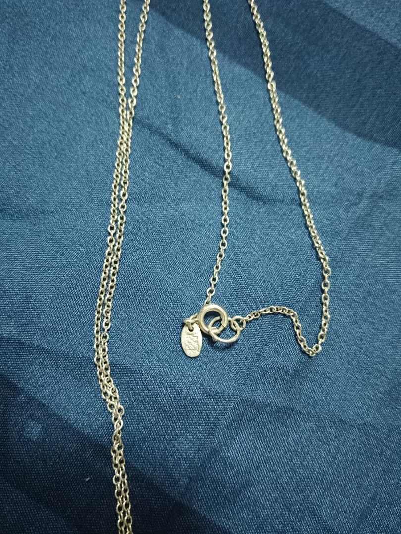 Silver Chain Necklace with Teardrop Pendant (Category: Necklaces) located in Manila. Submitted by clover_co. (Listing ID 1456208154, Image 1). Description: - Simple silver chain necklace - Features a long, thin chain - Adorned with a teardrop-shaped pendant - Clasp includes a small logo tag - Ideal for everyday wear or layering - Adjustable length for a perfect fit.