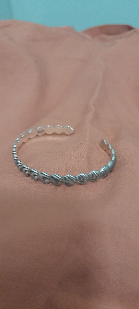 Silver Shell Pattern Cuff Bracelet (Category: Bracelets) located in Singapore. Submitted by lalaine83 (Listing ID 1456189704, Image 1). Description: - Cool silver cuff bracelet - Features a repeating shell pattern - Open cuff design for easy wear - Versatile accessory for any outfit - marked 925.