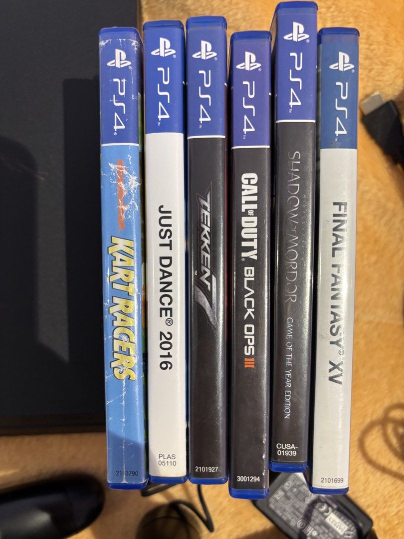 Sony PlayStation 4 PS4 Console with Games and Accessories (Category: PlayStation) located in Quezon City. Submitted by 2ndrepublic (Listing ID 1456128849, Image 3). Description: - Sony PlayStation 4 Console - Two (2) Controllers - Controller Charging Dock - PS Camera - Games Included: - Kart Racers - Just Dance 2016 - Tekken 7 - Call of Duty Black Ops III - Shadow of Mordor - Final Fantasy XV - Power Adapter and Cables Included.