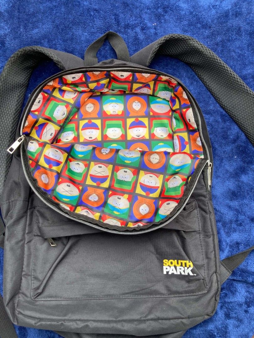South Park Backpack (Category: Backpacks) located in Naga. Submitted by grunchieeeerr (Listing ID 1456109476, Image 3). Description: Cool black South Park backpack with character print. Features a fun character grid lining, front pocket, and adjustable straps. Perfect for school or daily use. 13.5x18 .