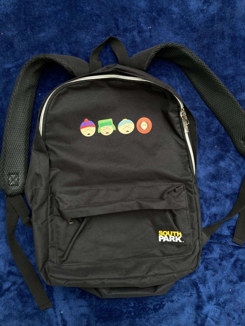 South Park Backpack (Category: Backpacks) located in Naga. Submitted by grunchieeeerr (Listing ID 1456109476, Image 2). Description: Cool black South Park backpack with character print. Features a fun character grid lining, front pocket, and adjustable straps. Perfect for school or daily use. 13.5x18 .