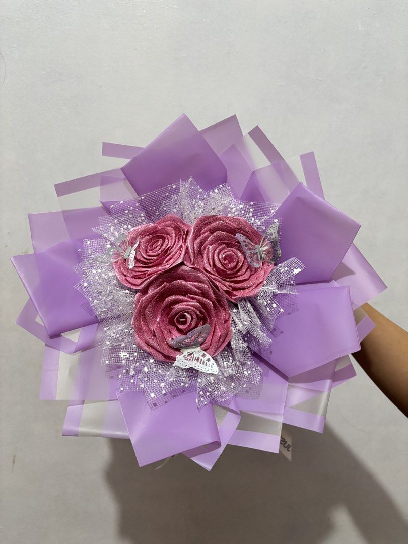 Sparkly Rose Bouquet with Butterflies (Category: Flowers & Bouquets) located in Bacoor. Submitted by owenjii (Listing ID 1456159128, Image 1). Description: - Handmade bouquet with 3 sparkly pink roses - Decorated with glittery butterflies - Wrapped in purple paper - Tied with a 'Just For You' ribbon - Ideal for gifts or decorations - Ready to give!.