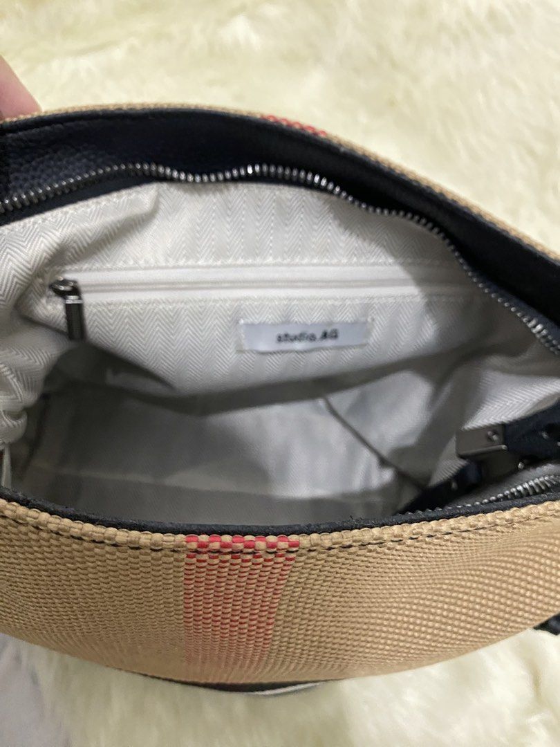 Studio AG Canvas and Leather Crossbody Bag (Category: Cross-body Bags) located in San Antonio. Submitted by clinicallycute_. (Listing ID 1456175469, Image 3). Description: - Studio AG canvas and leather crossbody bag - Signature check pattern - Tassel detail on the side - Interior zip pocket - Clean interior - Adjustable strap.