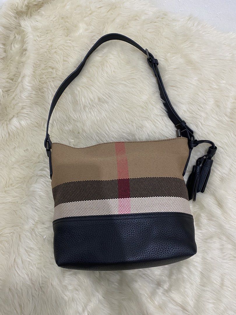 Studio AG Canvas and Leather Crossbody Bag (Category: Cross-body Bags) located in San Antonio. Submitted by clinicallycute_. (Listing ID 1456175469, Image 2). Description: - Studio AG canvas and leather crossbody bag - Signature check pattern - Tassel detail on the side - Interior zip pocket - Clean interior - Adjustable strap.