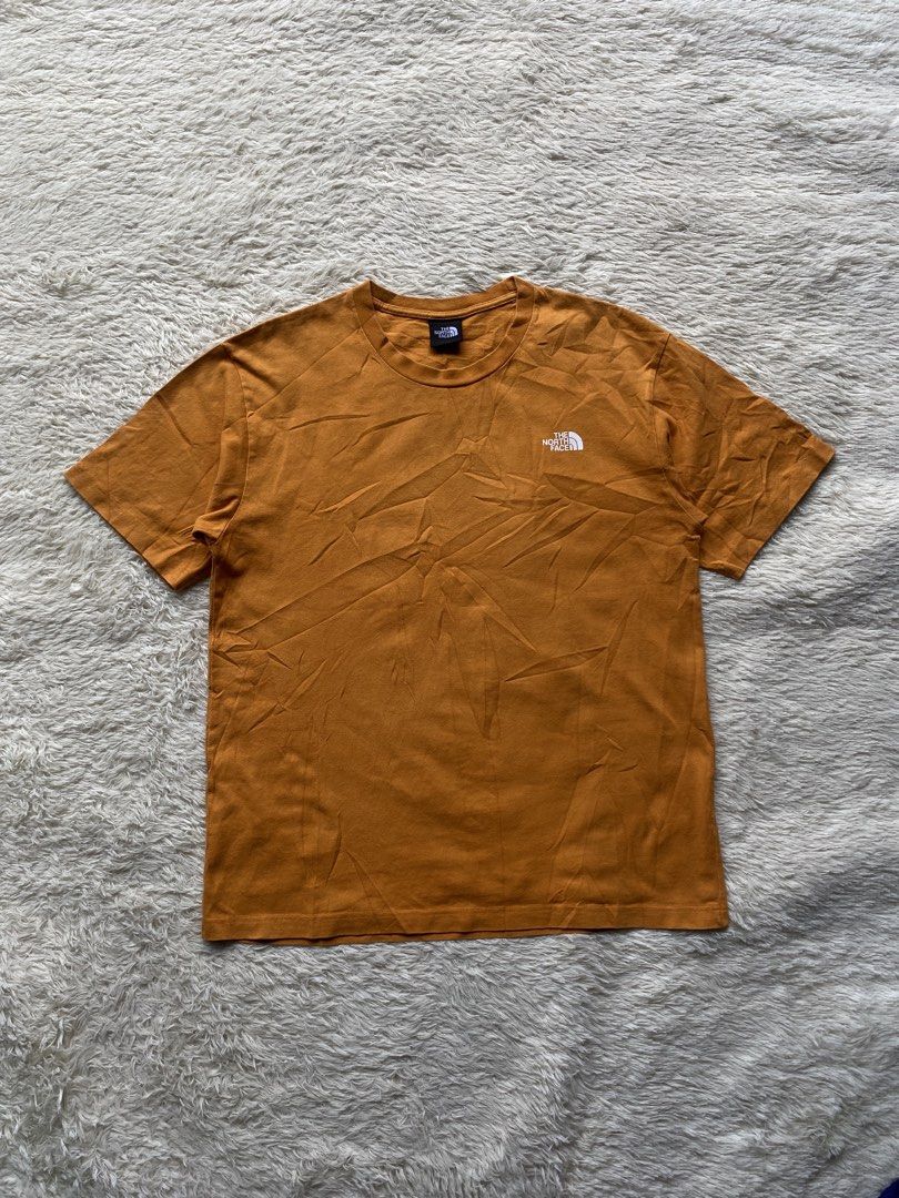 The North Face "Never Stop Exploring" Graphic T-Shirt (Category: Tshirts & Polo Shirts ) located in Cebu City. Submitted by deethirdd (Listing ID 1456186713, Image 2). Description: - Brand: The North Face - Color: light brown - Design: Graphic print on back with "Never Stop Exploring" slogan, small logo on front chest - Material: Comfortable cotton - Style: Great for casual wear.